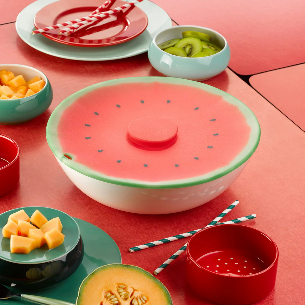 Children's tableware set with watermelon design on a red surface