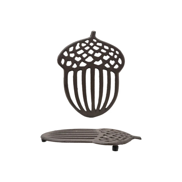 Cast iron acorn-shaped trivet on a white background