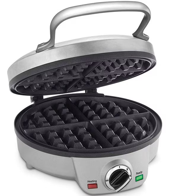 A silver and black electric waffle maker shown open on a white background, with a top handle, two rows of waffle molds, and a control dial on the front with heating and ready indicators.