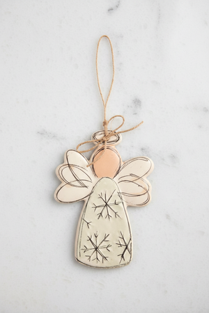 Decorative angel ornament with snowflake patterns on a white background