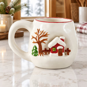 White stoneware mug with a red rim and a raised 3D red cabin, bare tree, and small evergreen.