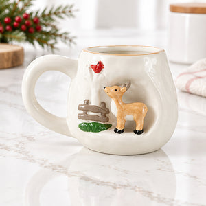 White stoneware mug with a raised 3D deer beside a wooden fence and a red cardinal.