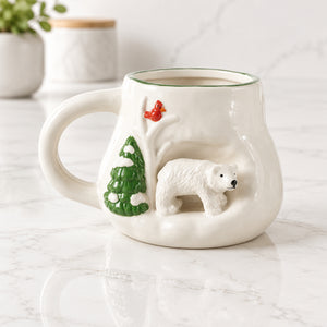 White stoneware mug with a raised 3D polar bear beside an evergreen tree and a red cardinal.