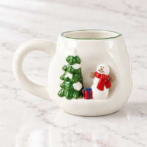 White stoneware mug with a raised 3D snowman in a red scarf beside a snowy green tree.