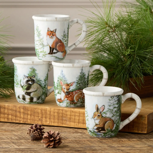 Porcelain mug with a painted winter scene of snowy evergreens and woodland wildlife.