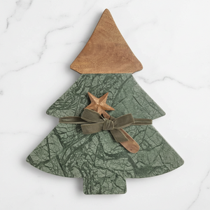 A Christmas tree-shaped decorative wall piece with a wood-grain brown top, a green camouflage-patterned lower body, a brown ribbon bow, and a small wooden star accent, shown on a plain white background.