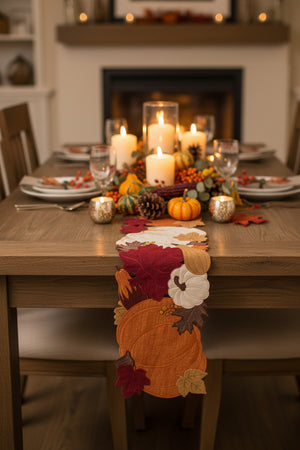 A long, narrow decorative runner featuring an autumn leaf and pumpkin pattern in orange, burgundy red, brown, and cream on a white background.