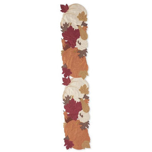 A long, narrow decorative runner featuring an autumn leaf and pumpkin pattern in orange, burgundy red, brown, and cream on a white background.