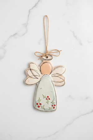 Decorative angel ornament with a string for hanging on a white background