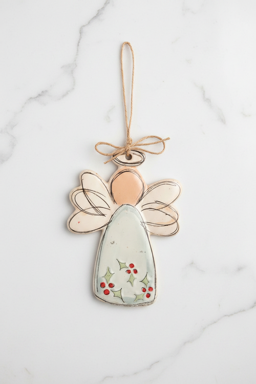 Decorative angel ornament with a string for hanging on a white background