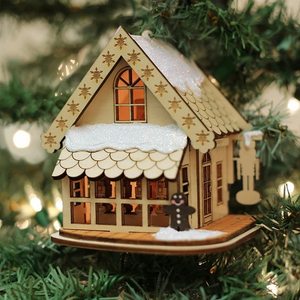 Wooden Drosselmeyer’s Nutcracker shop cottage ornament glowing from a tree light bulb inside.
