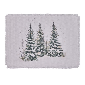 White woven cotton placemat with fringed edges and a watercolor of three snow-covered spruce trees.
