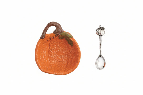 An orange pumpkin-shaped serving dish with a brown stem and leaf detail, shown next to a small silver spoon with a pumpkin-shaped handle, on a white background with a 'Click to zoom' label.