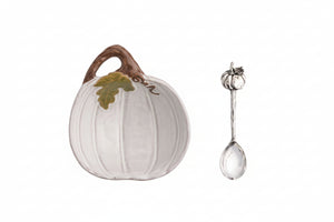A white ceramic pumpkin-shaped dish with a brown handle and green leaf detail, shown next to a silver spoon with a pumpkin-shaped handle, on a white background with a 'Click to zoom' button.