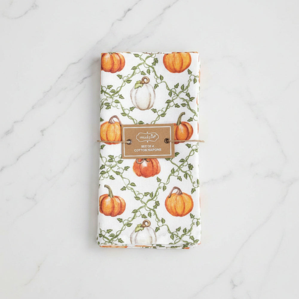 A set of 4 white cotton napkins featuring a watercolor autumn pumpkin pattern with green vines, tied together with a twine bundle and a brown paper label.