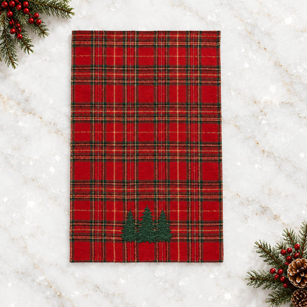 Red plaid woven kitchen towel with yellow and green accents and embroidered green spruce trees along the edge.
