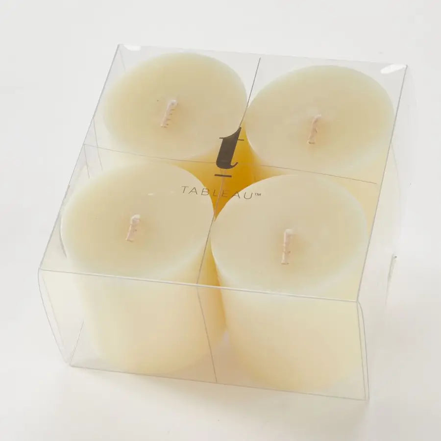 A single cream-colored pillar candle with a natural wick, standing upright on a neutral light gray background.