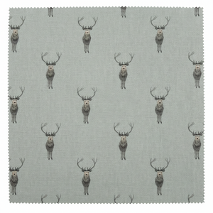 A square fabric swatch with serrated edges showing a repeating pattern of gray and brown deer on a light sage background,