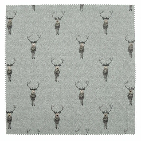 A square fabric swatch with serrated edges showing a repeating pattern of gray and brown deer on a light sage background,