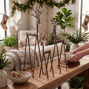 Aspen Kitchens Home+Gift set of three rustic bronze iron deer figurines with branch-like antlers on a wooden table.