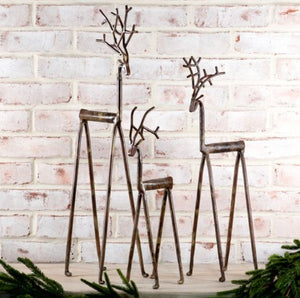 Aspen Kitchens Home+Gift set of three rustic iron deer figurines with weathered bronze finish and branch antlers.