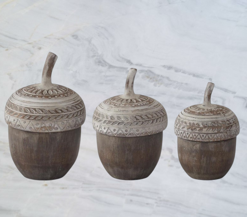 Aspen Kitchens Home+Gift resin acorn containers with whitewashed lids in three sizes on a wooden desk