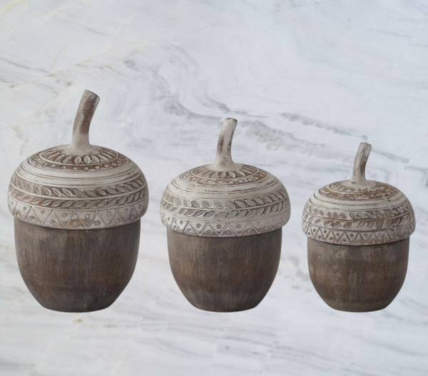 Aspen Kitchens Home+Gift set of three resin acorn-shaped storage containers with decorative whitewashed lids.