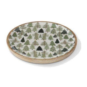 round mango wood tray with an enameled white center printed with green evergreen trees.