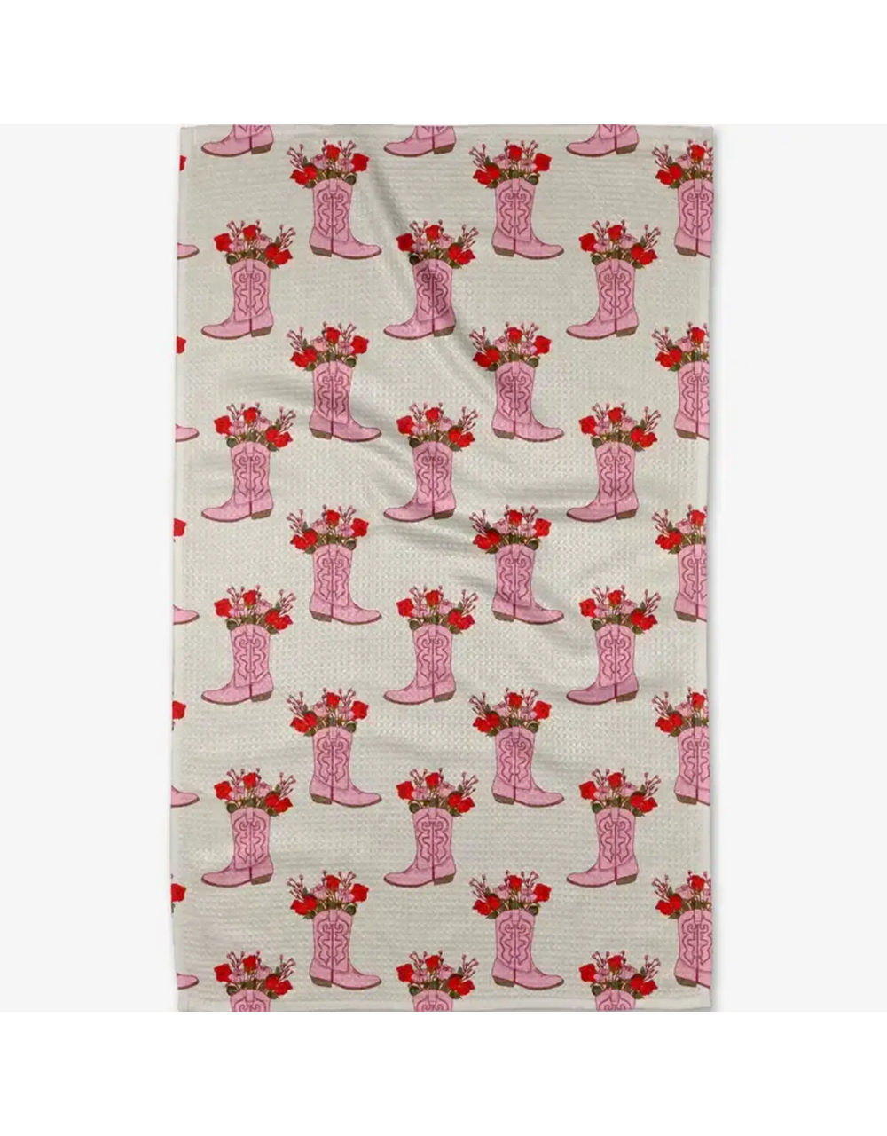 A rectangular fabric item, likely a tea towel or kitchen towel, featuring a repeating pattern of pink cowboy boots filled with red roses on a light beige background.