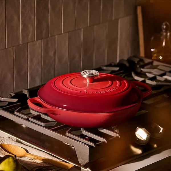 Le Cresuet Braiser in the color Cerise on a stovetop