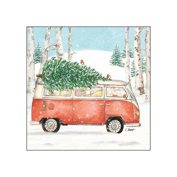 A watercolor-style cocktail beverage napkin of a red and cream vintage camper van driving through a snowy winter forest, with a large green Christmas tree strapped to the roof and small birds perched on the tree. The scene is framed by birch trees and evergreen trees under a pale blue sky.