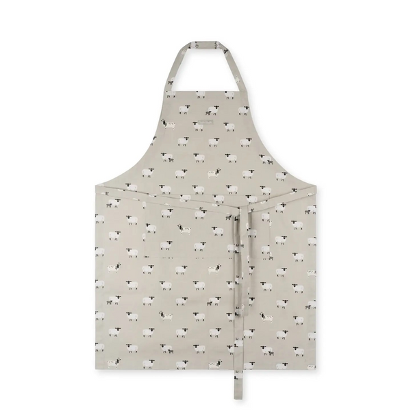 A light beige apron with a repeating pattern of black sheep, featuring a neck strap and waist ties, shown against a plain white background.