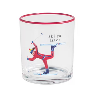 A clear glass tumbler with a red rim, featuring a printed illustration of a skier in a red suit performing a trick with the text 'ski ya later' on a white background.