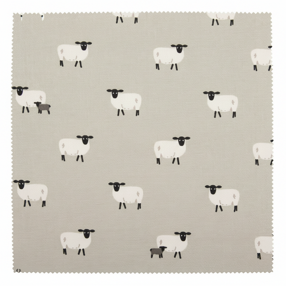 A light beige apron with a repeating pattern of black sheep, featuring a neck strap and waist ties, shown against a plain white background.