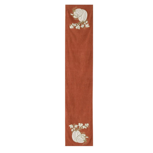 A long, narrow terracotta-colored runner or table runner with embroidered autumn motifs, including pumpkins and white flowers, shown on a plain white background.