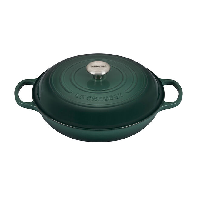 Le Creuset Braiser in the color artichaut on a wood cutting board