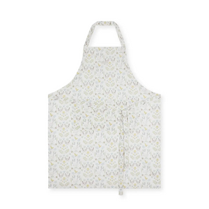 A white apron with a delicate, repeating botanical pattern in soft yellow and gray, shown flat against a solid white background.