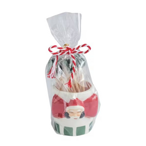 A Christmas-themed toothpick holder packaged in a clear cellophane bag tied with a red and white striped bow. The holder is shaped like Santa's face