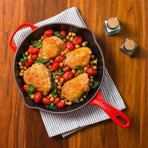 Le Creuset Skillet in the color Cerise on a kitchen towel