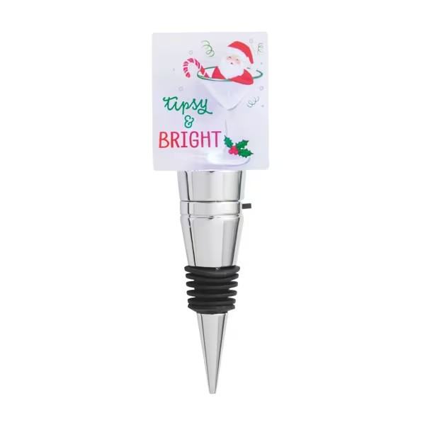 A Christmas-themed wine bottle stopper with a silver metal cone body, a black rubber grommet base, and a white paper header card featuring Santa and the words 'Tipsy & BRIGHT'.