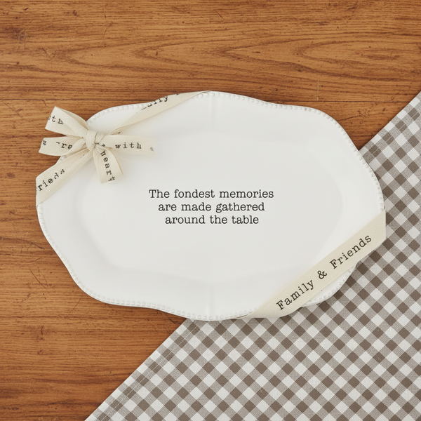 White platter that Says "The Fondest Memories are made gathered around the Table"