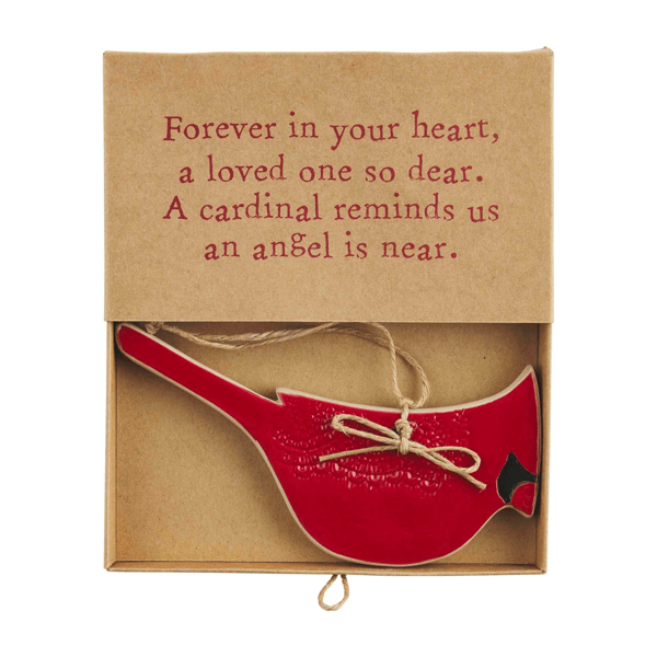 Red cardinal ornament in a box with a sentimental message on a white background