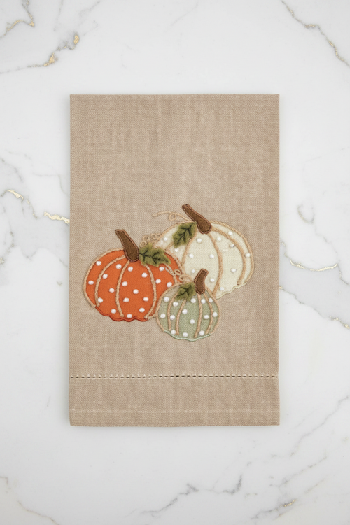 Decorative kitchen towel with pumpkins on a beige background