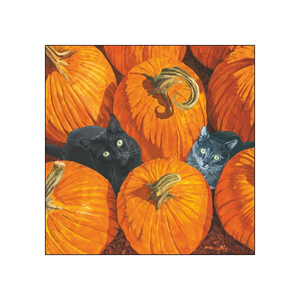 A cocktail napkin depicting two black cats peeking out from among bright orange pumpkins, shown against a plain white background.