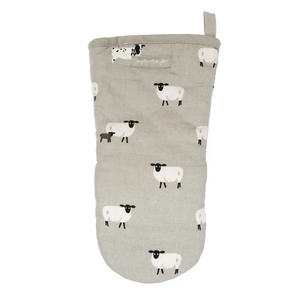 A light gray quilted oven mitt featuring a repeating pattern of black and white sheep, with a small fabric brand label near the top and a loop handle.