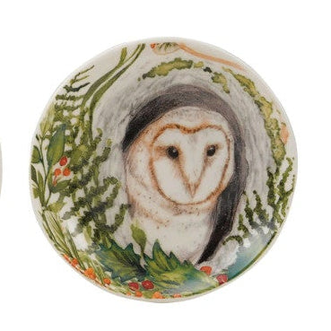 Four round ceramic coasters with animal illustrations on a white background