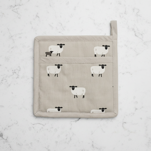 A square beige fabric pot holder featuring a repeating pattern of white sheep, with a top loop handle and a small side tag.