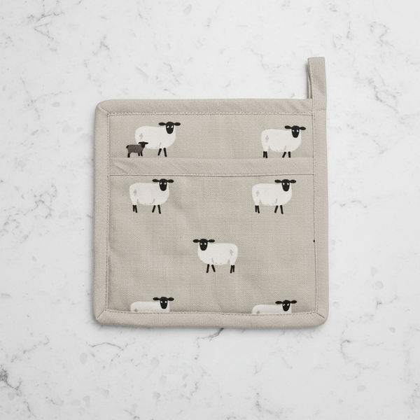 A square beige fabric pot holder featuring a repeating pattern of white sheep, with a top loop handle and a small side tag.