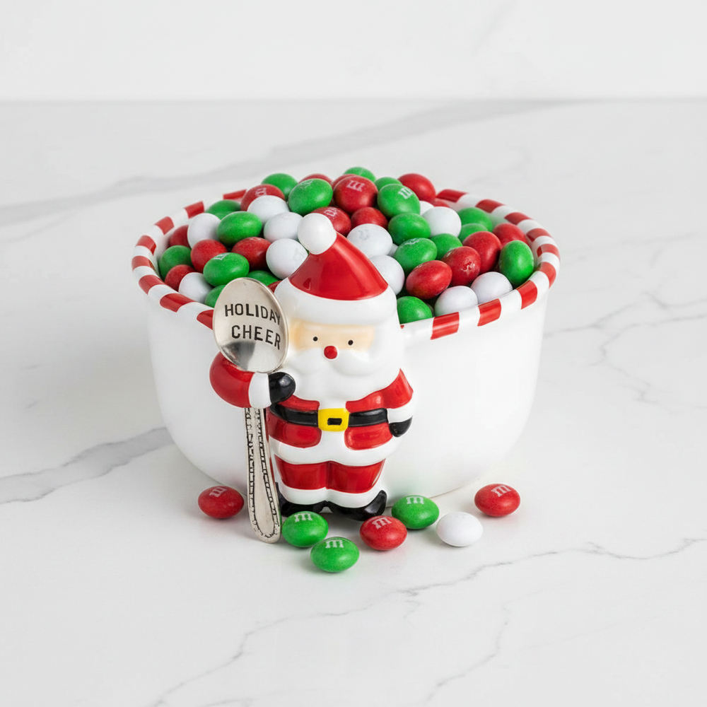 A white ceramic Christmas-themed snack bowl with a snowman figure holding a spoon inside. The bowl features red and white striped trim and the text 'Snow better snacks' printed inside.